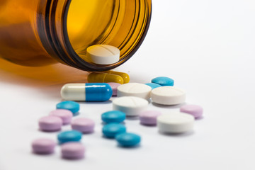 Diferent tablets pills heap mix on white isolated background