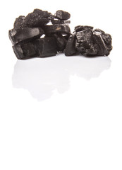 Lump of charcoal over white background