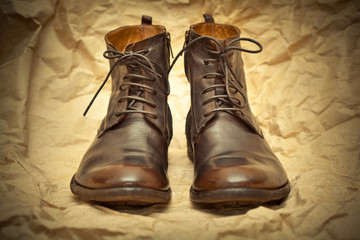 Fashionable high boots on a vintage background.