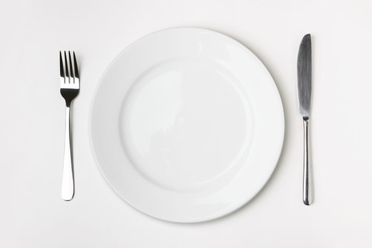 Knife, Fork and plate on table.
