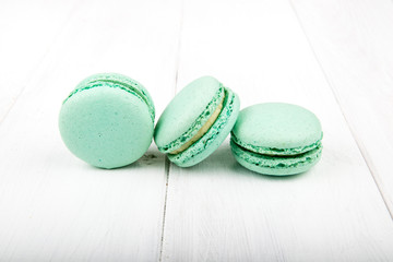 Set of macarons on white wooden table