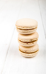 Set of macarons on white wooden table