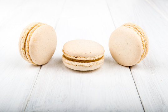 Set of macarons on white wooden table