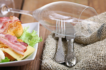 Serving breakfast toast with bacon and herbs