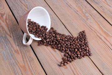 Cup with coffee beans on a wooden table