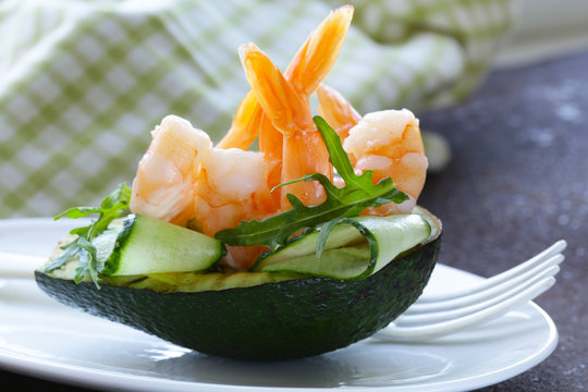 Fresh avocado with shrimp and cucumber served on a plate