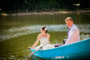 beautiful newlyweds in wedding day in a boat
