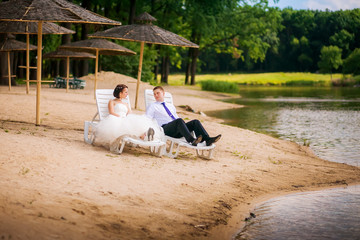 beautiful newlyweds in wedding day on the lake