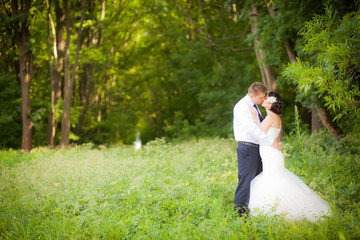 beautiful newlyweds in wedding day in the woods