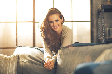 Portrait of happy young woman in loft apartment
