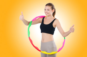 Woman doing exercises with hula hoop