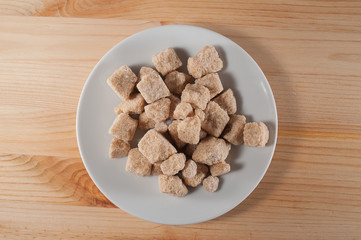 pieces cane sugar on a white saucer