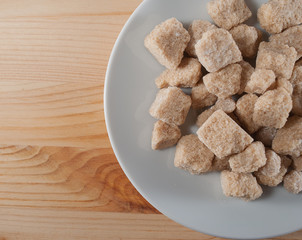 pieces cane sugar on a white saucer