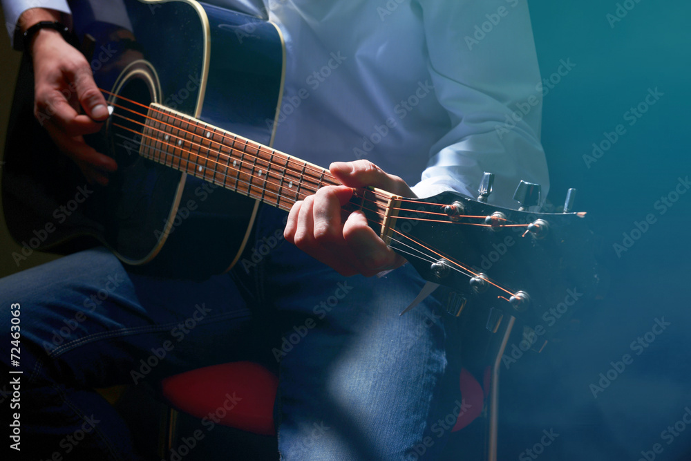 Sticker young musician playing acoustic guitar on dark background