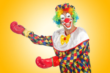 Clown with boxing gloves isolated on white
