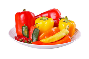 Mixed hot and sweet peppers in a bowl isolated on white