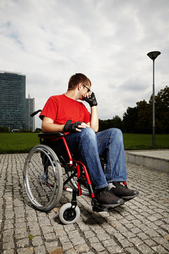 Young man on wheel chair - ordinary day in life