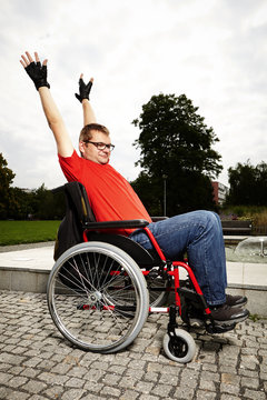 Young man on wheel chair - stretching