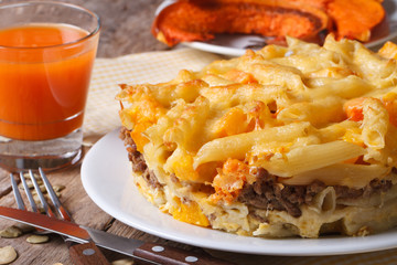 Baked Pasta with meat, cheese,  pumpkin and juice. Horizontal