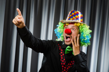 Funny clown in humorous concept against curtain