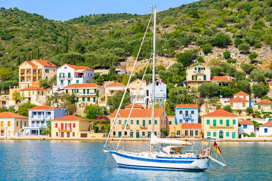 Fototapeta Yacht on sea and colorful houses of Vathi town, Ithaka island