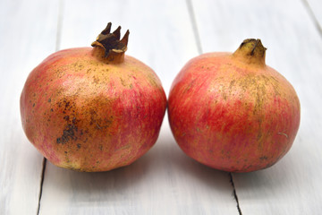 Delicious fresh fruit, ripe juicy pomegranates isolated on white