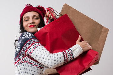 Shopping winter woman embracing shopping bags