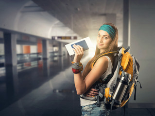 Happy traveler woman is waiting for a flight
