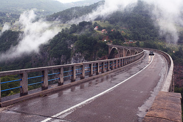 bridge in the mountains fog clouds rain