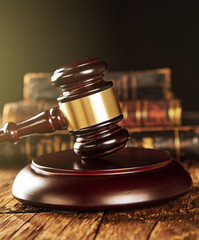 Wooden gavel and books on wooden table