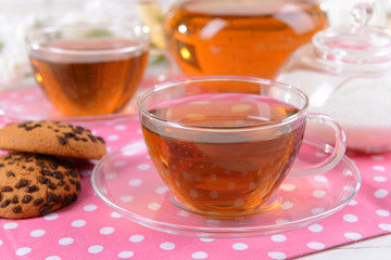 Teapot and cups of tea on table close-up