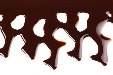 Melted chocolate dripping on white background