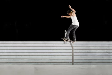 Fotobehang Skateboard Boy doing skateboard trick on rail  © KopoPhoto