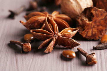 Stars anise with nutmeg and carnation on wicker background