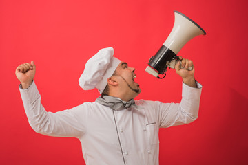 Portrait of caucasian man with chef uniform holding megaphone