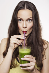 Portrait of a Woman Drinking Green Fruit Juice