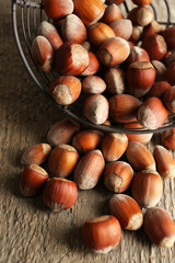Hazelnuts in basket on wooden background