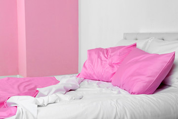 Crumpled pink linen on bed