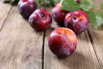 Sweet plums on wooden background