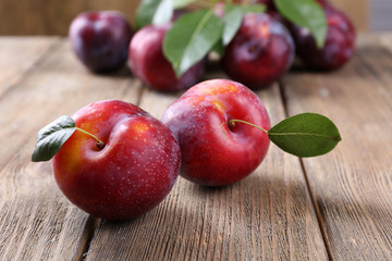 Sweet plums on wooden background