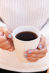 Woman holding cup of tasty hot drink, close-up,