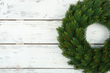 Decorative Christmas wreath on wooden background