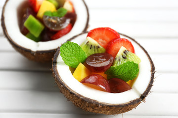 Fruit salad in coconut on table