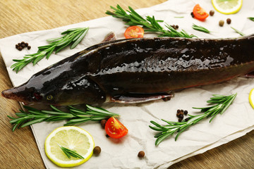Fresh raw fish and food ingredients on table