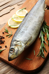 Fresh raw fish and food ingredients on table