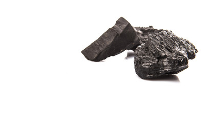 Lump of charcoal over white background