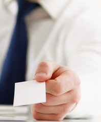 Portrait of young handsome business man holding blank white