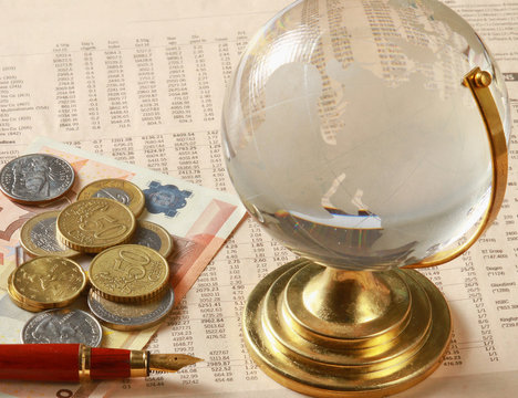 Money: euro coins and bills close up and glode