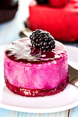 Souffle, cake berry, jelly on the wooden blue background