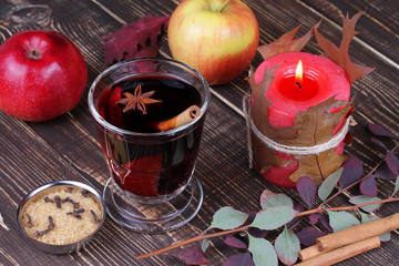 Mulled wine and spices on wooden background